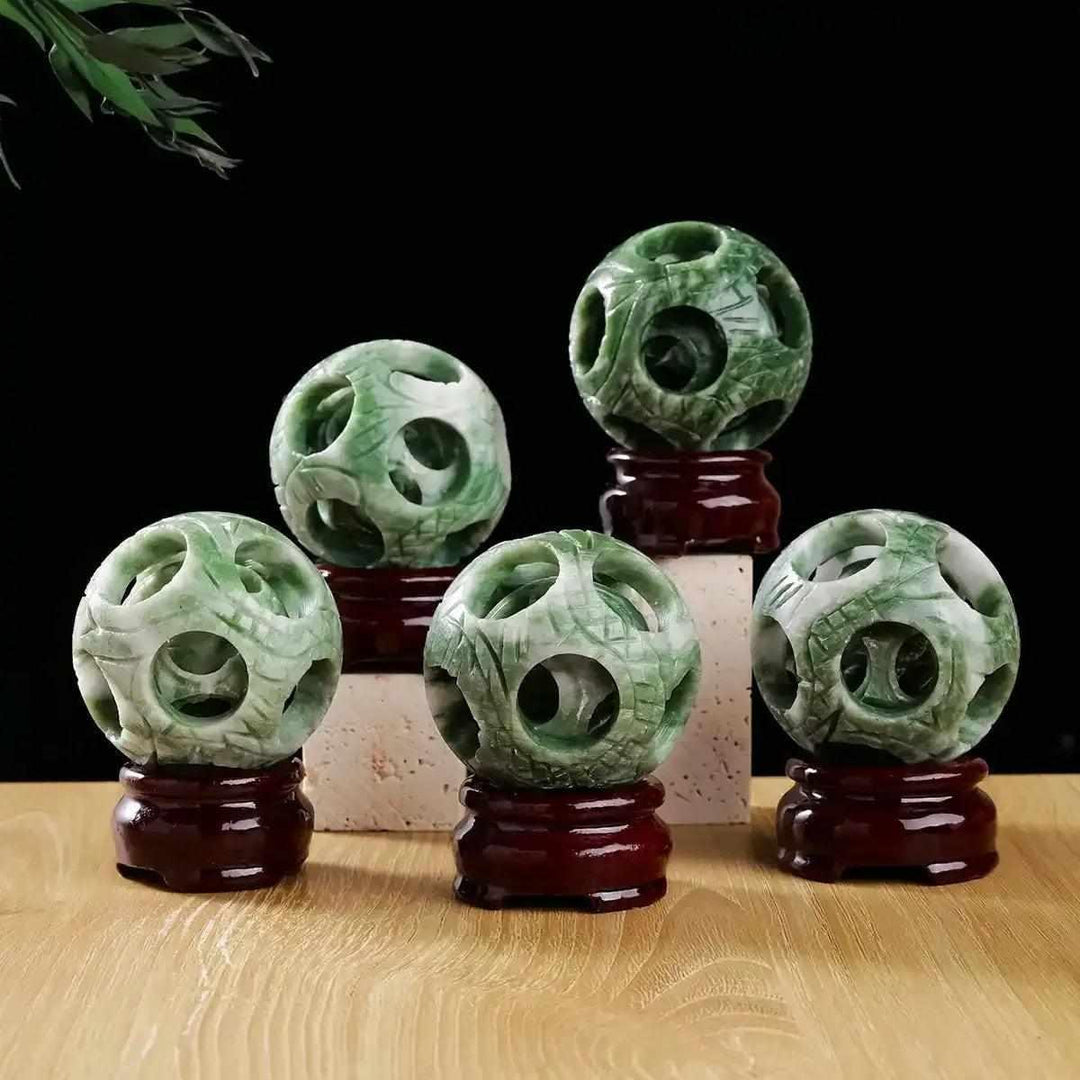 Lushan Jade 3-in-1 openwork sphere with green and cream patterns, featuring intricate carvings for balance and wholeness.