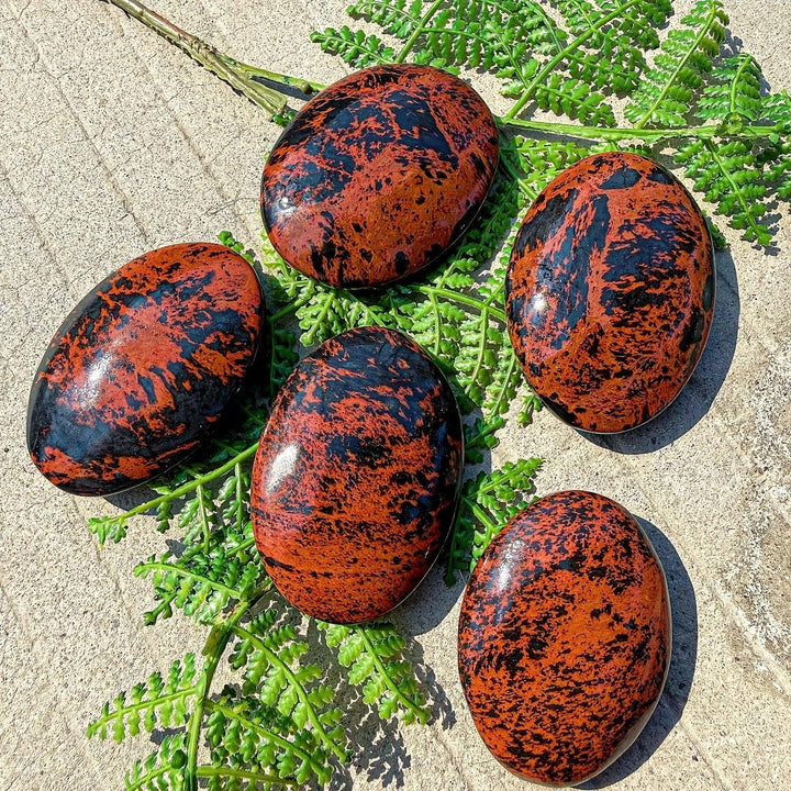 Natural Bohemian mahogany obsidian palm stone with striking red-brown and black veining for healing home decor.