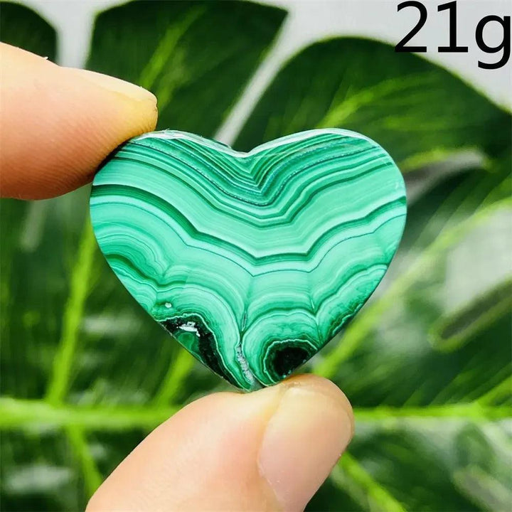 Handcrafted Malachite Crystal Heart, a polished deep forest green stone with mesmerizing bands, radiating protective energy.