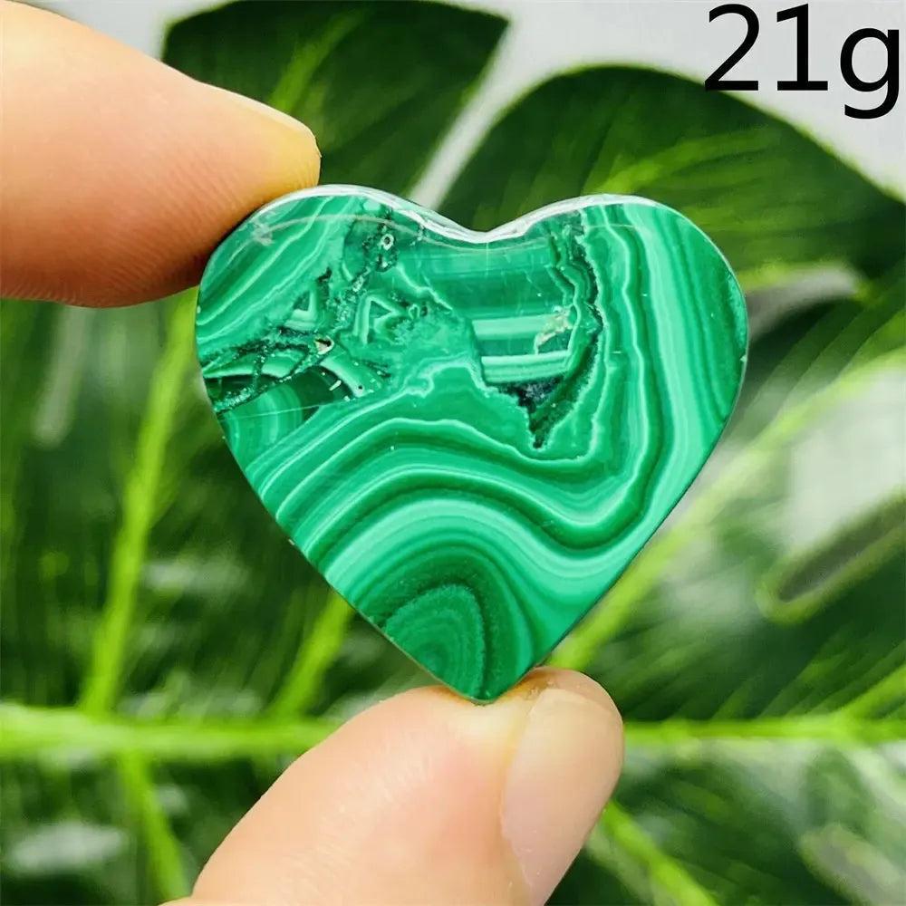 Malachite Crystal Heart: Polished deep forest green heart with mesmerizing bands, promoting emotional healing and spiritual growth.