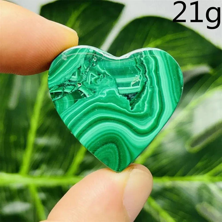 Malachite Crystal Heart: Polished deep forest green heart with mesmerizing bands, promoting emotional healing and spiritual growth.