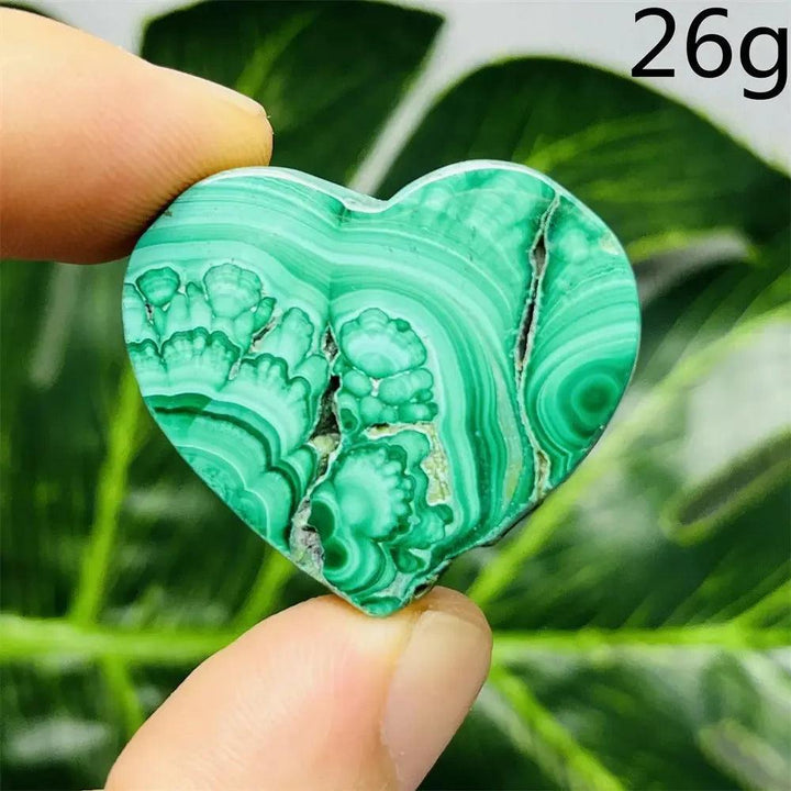 Malachite Crystal Heart: Polished deep forest green heart with mesmerizing bands, radiating powerful protective energy.