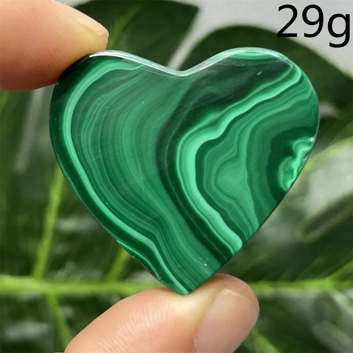 Malachite Crystal Heart: Polished deep forest green heart with mesmerizing banded patterns, radiating protective energy.