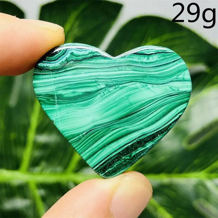 Malachite Crystal Heart: Polished deep forest green heart with mesmerizing bands, radiating powerful protective energy.