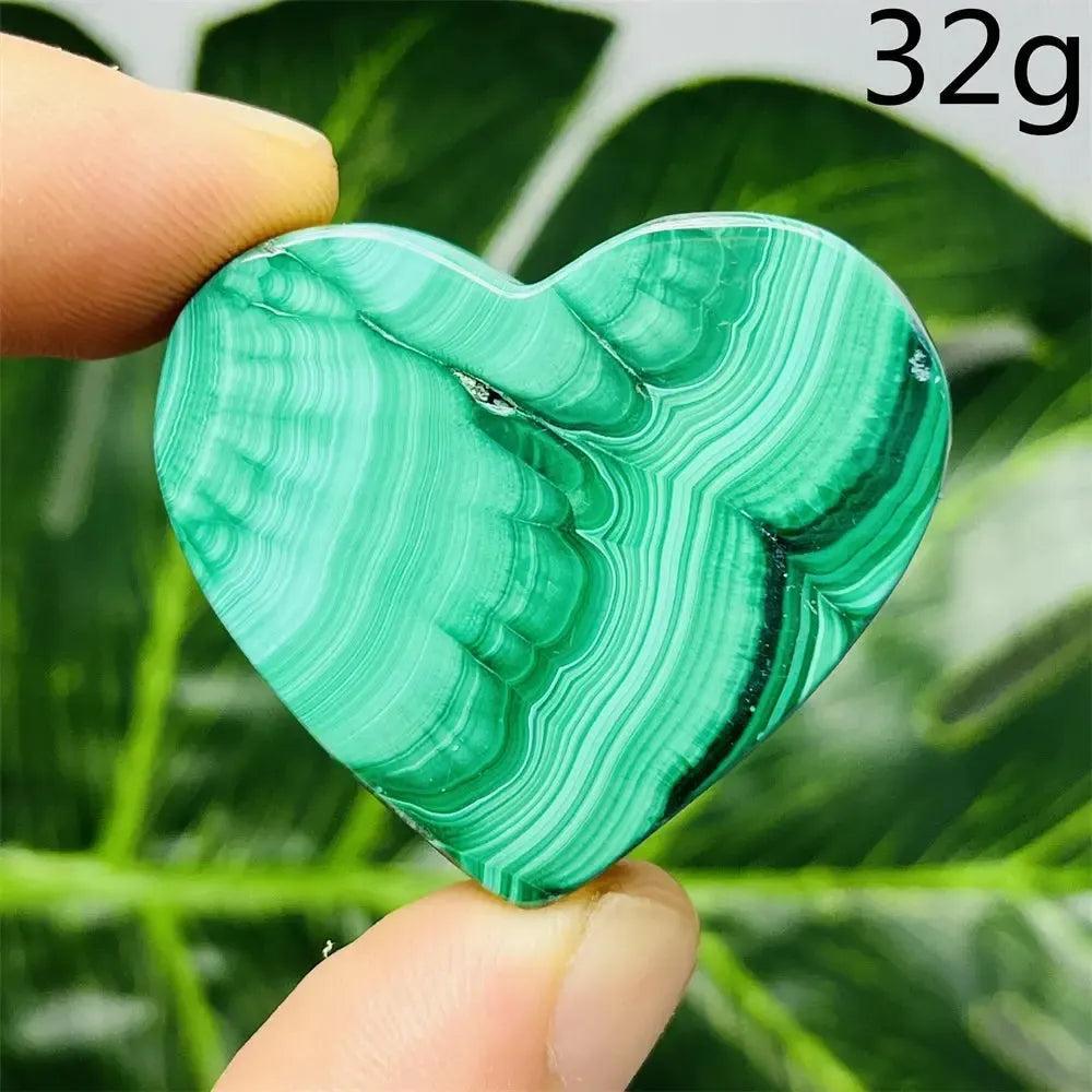 Malachite Crystal Heart: Polished deep forest green heart with mesmerizing bands, radiating powerful protective energy.