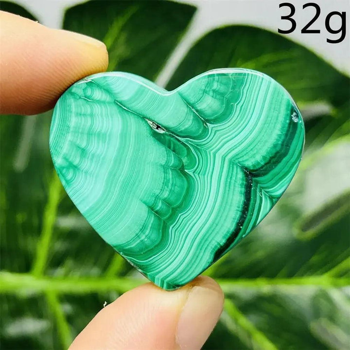 Malachite Crystal Heart: Polished deep forest green heart with mesmerizing bands, radiating powerful protective energy.