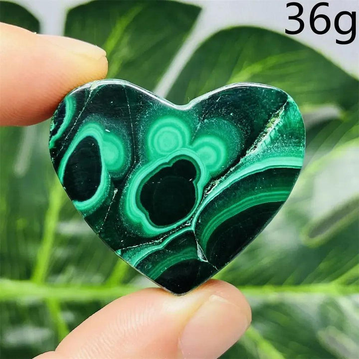 Malachite Crystal Heart: Polished deep forest green stone with mesmerizing bands, radiating powerful protective energy.
