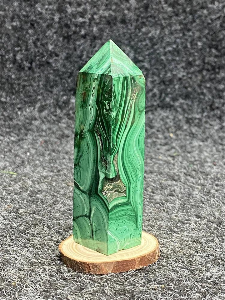 Polished Malachite hexagonal obelisk tower with vibrant green banded patterns for healing and transformation.