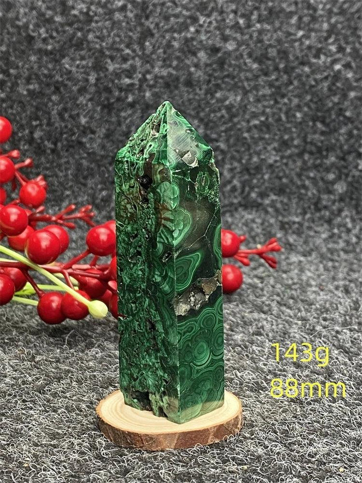 Polished Malachite hexagonal obelisk tower featuring vibrant green banded patterns for healing and transformation.