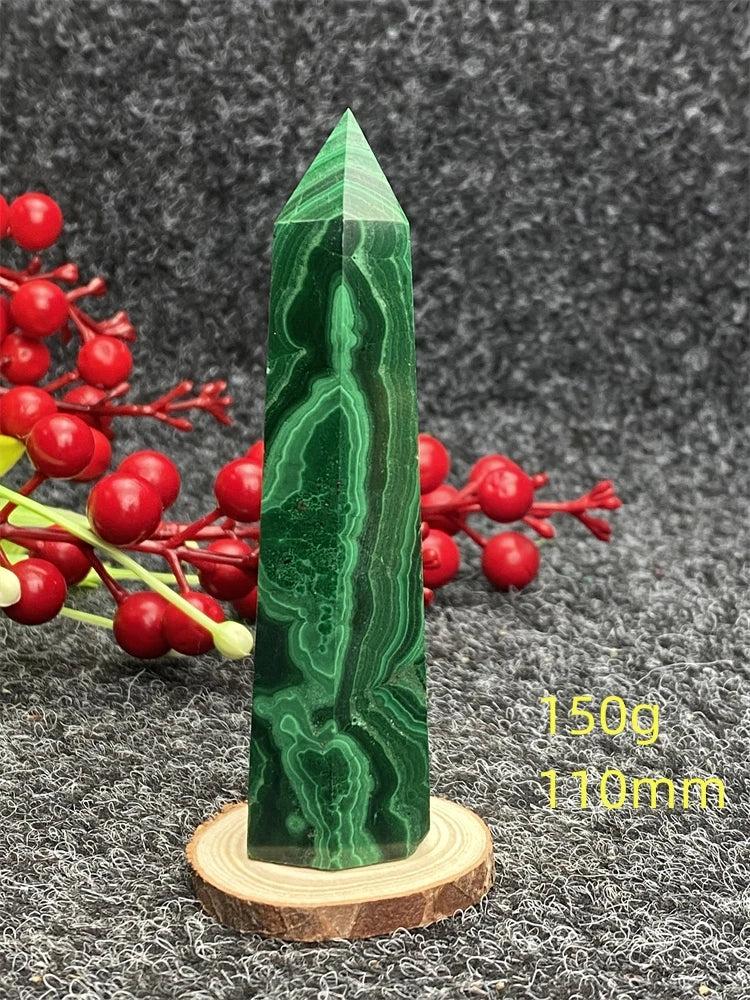 Polished malachite hexagonal obelisk tower with vibrant green banded patterns for healing, growth, and transformation.