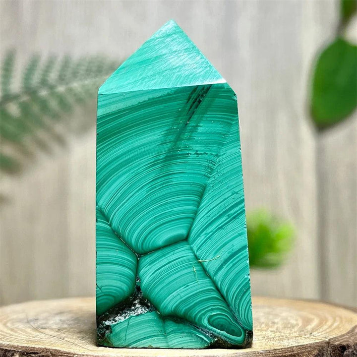 Polished Malachite Crystal Obelisk Tower featuring vibrant, deep green banded patterns for heart chakra healing.