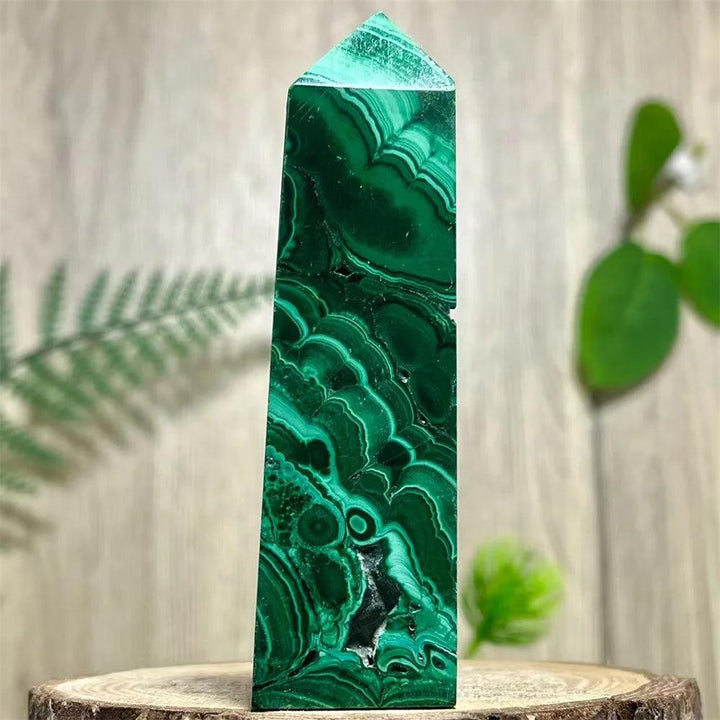 Polished Malachite Crystal Obelisk Tower featuring deep green swirling bands for heart chakra healing and transformation.