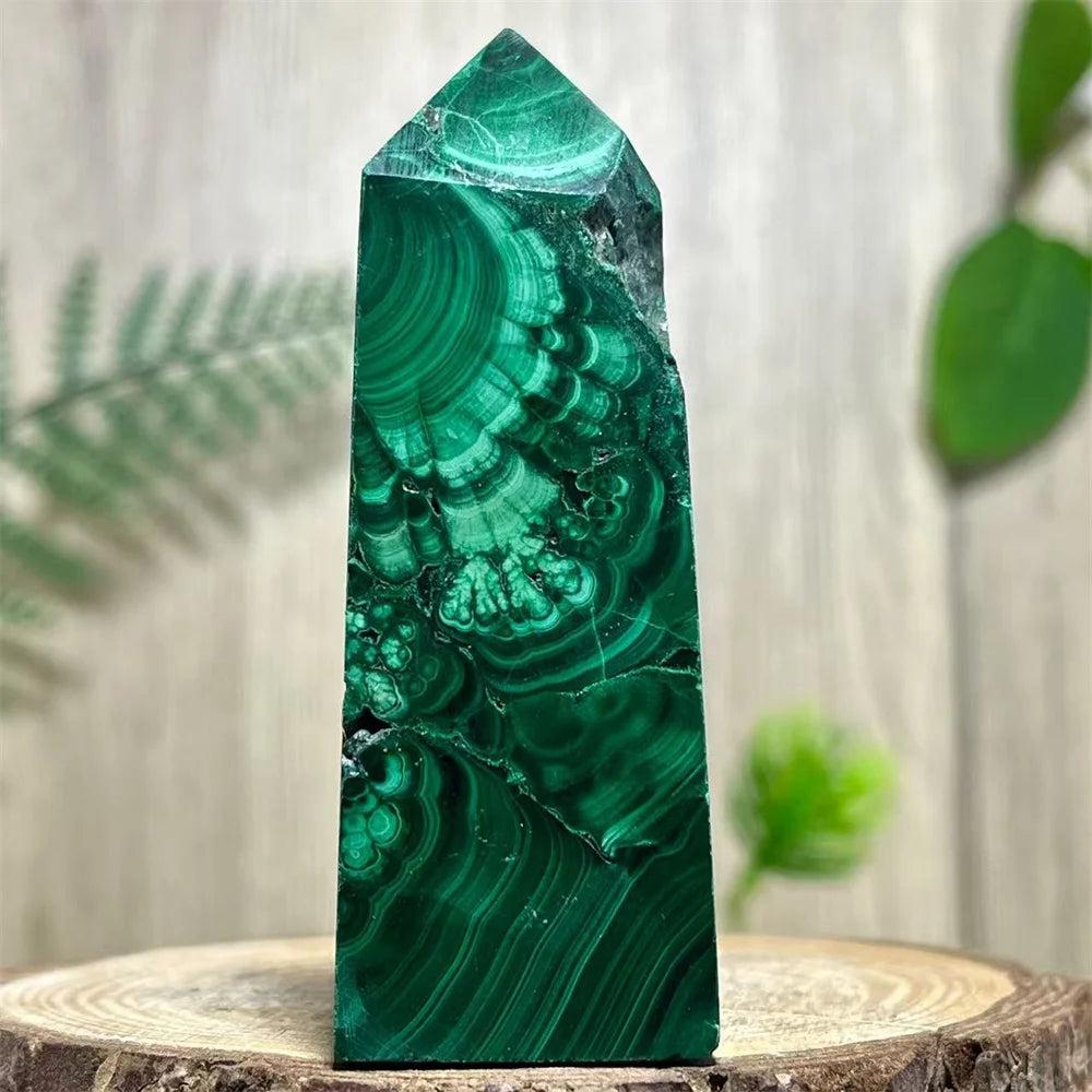 Polished Malachite crystal obelisk tower featuring vibrant, deep green banded patterns for heart chakra healing.