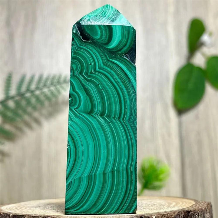 Polished Malachite crystal obelisk tower featuring vibrant, swirling green bands for heart chakra healing and energy.