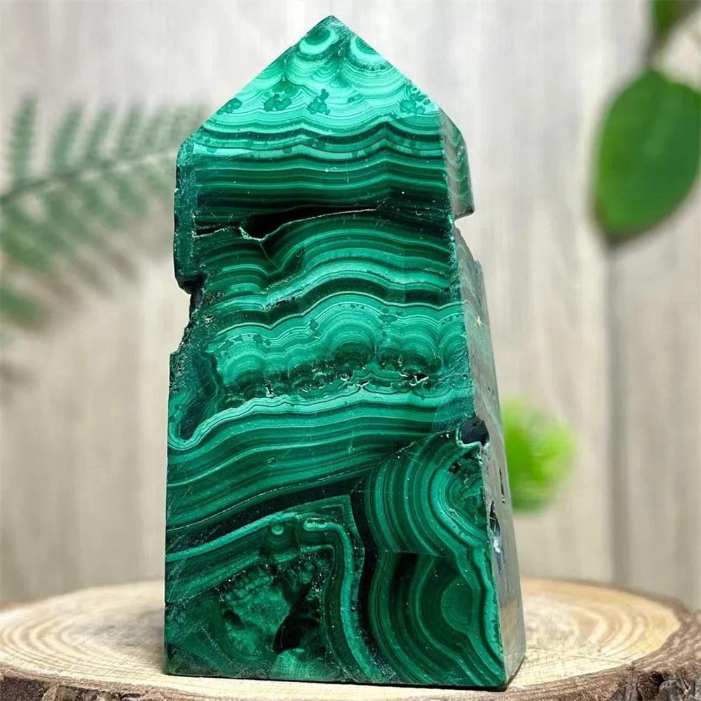 Polished Malachite Crystal Obelisk Tower with deep green banded patterns for heart chakra healing and transformation.