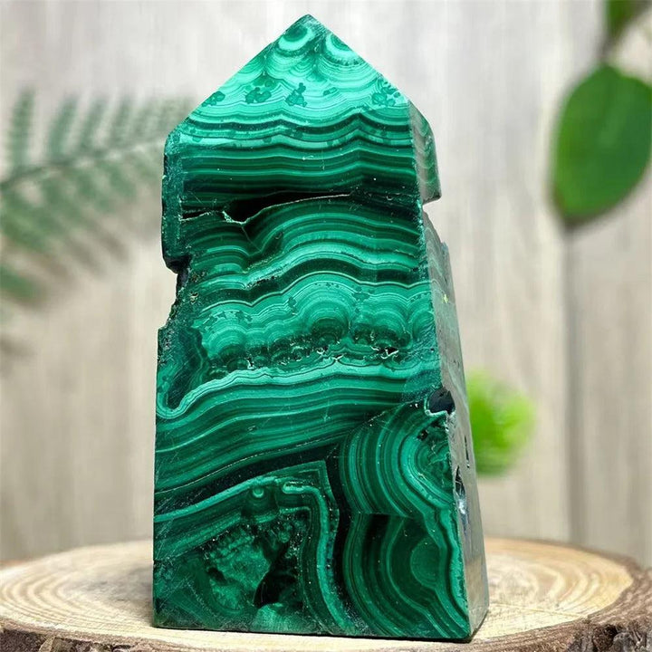 Polished Malachite Crystal Obelisk Tower with deep green banded patterns for heart chakra healing and transformation.