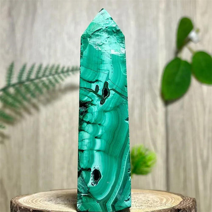 Polished Malachite Crystal Obelisk Tower with striking green banded patterns for heart chakra healing and transformation.