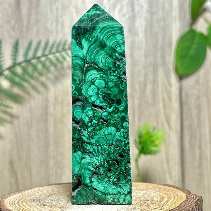 Polished Malachite Crystal Obelisk Tower with deep green banded patterns for heart chakra healing and transformation.