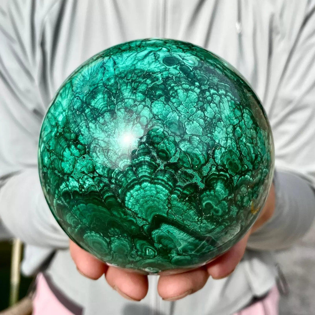 Polished Malachite crystal sphere featuring vivid forest green banded patterns for heart chakra healing and energy.