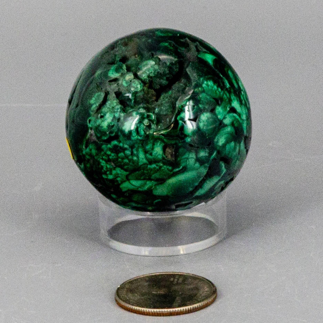 Malachite Sphere, Protective Healing Crystal, showcasing deep forest green and mint concentric rings on a clear stand.