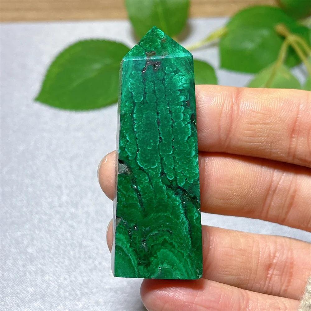 Polished Malachite crystal tower with vibrant green banded patterns for heart chakra healing and transformation.