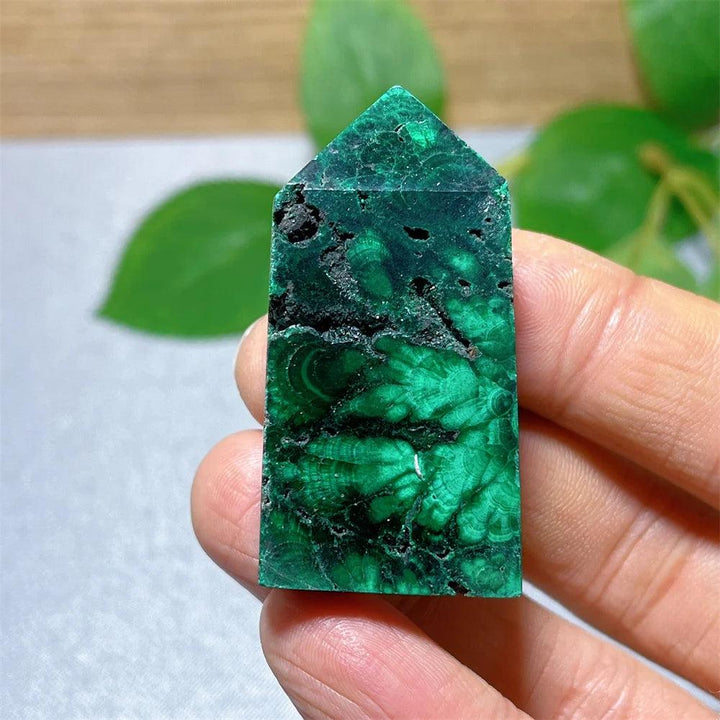 Polished Malachite Crystal Tower featuring deep green banded patterns for transformation and heart chakra healing.