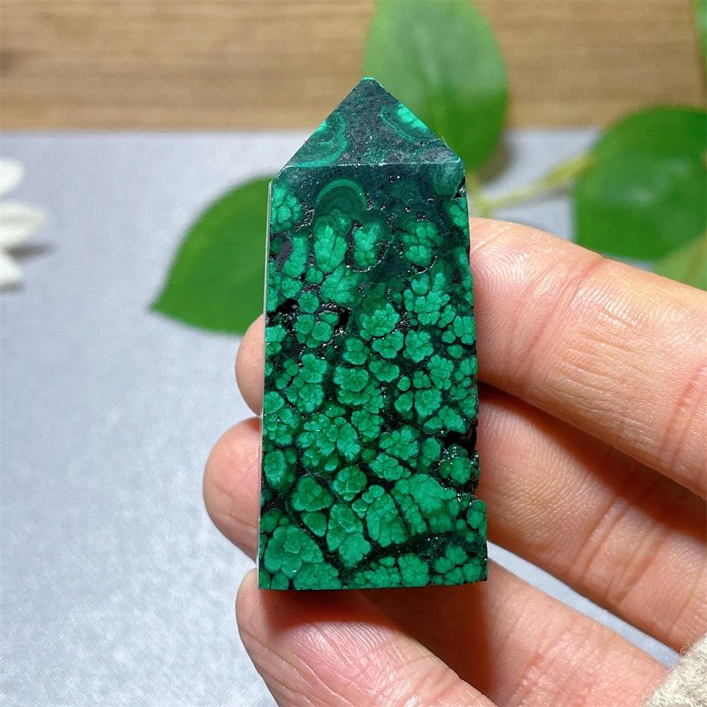 Polished Malachite crystal tower featuring vibrant green banded patterns for transformation and heart chakra healing.