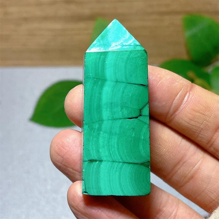 Polished Malachite Crystal Tower featuring vibrant green banded patterns for healing, transformation, and energy work.