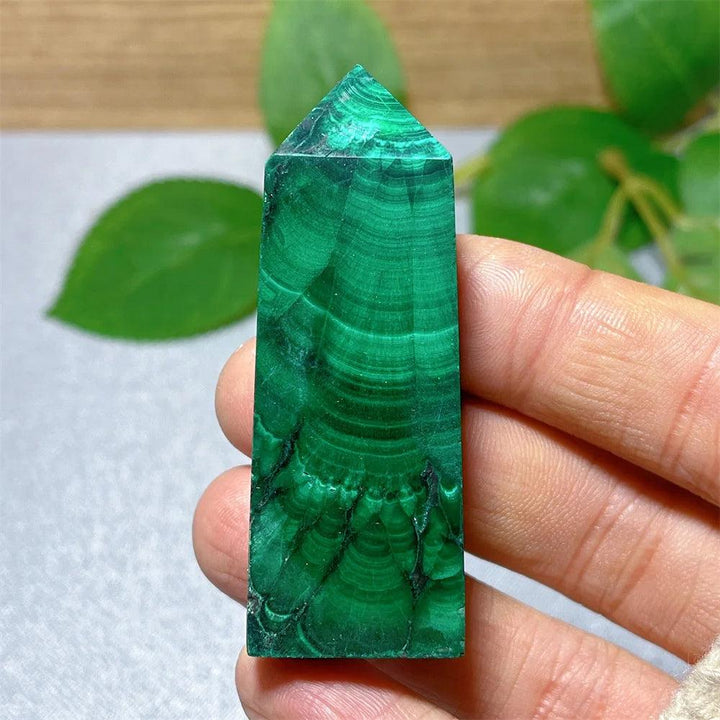 Polished Malachite crystal tower with vibrant green banded patterns for healing, transformation, and heart chakra work.