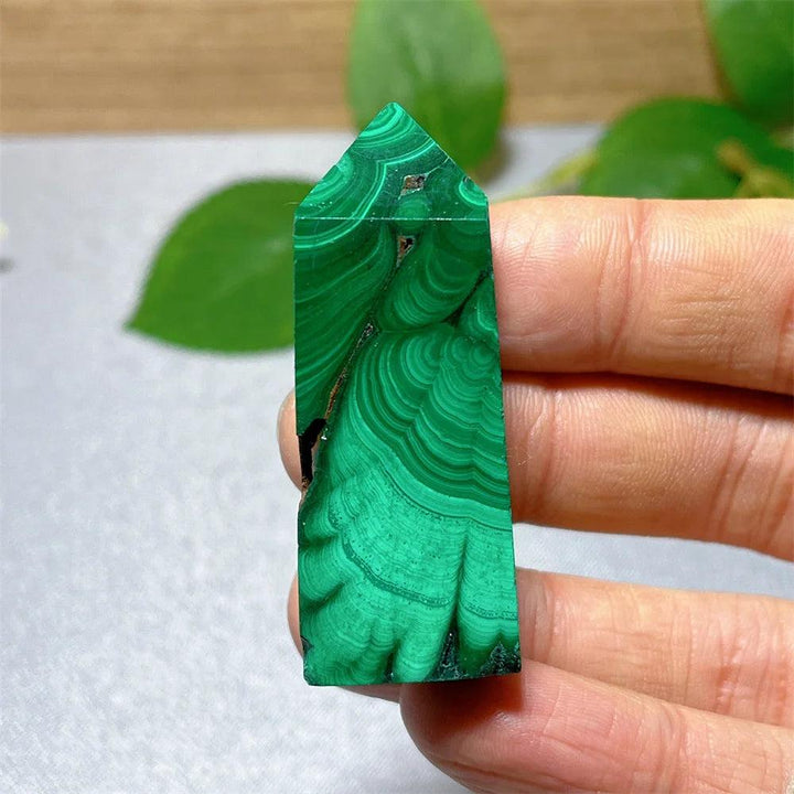 Polished Malachite Crystal Tower featuring vibrant green banded patterns for healing, transformation, and energy work.
