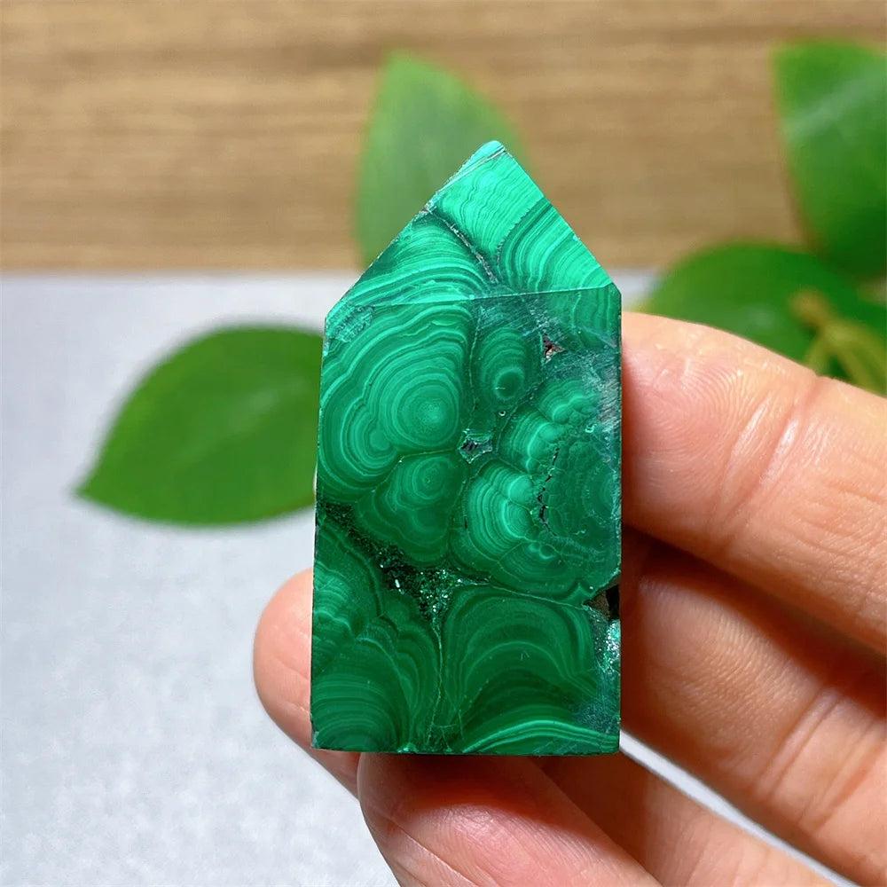 Polished Malachite Crystal Tower featuring vibrant green banded patterns for heart chakra healing and transformation.