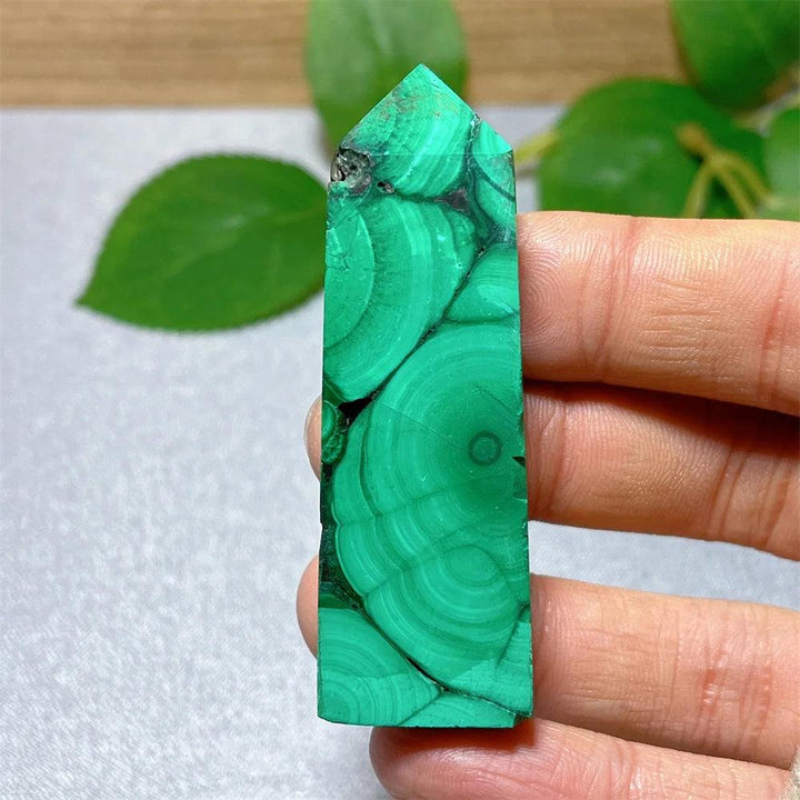 Polished Malachite crystal tower with vibrant green banded patterns, perfect for healing and transformation.