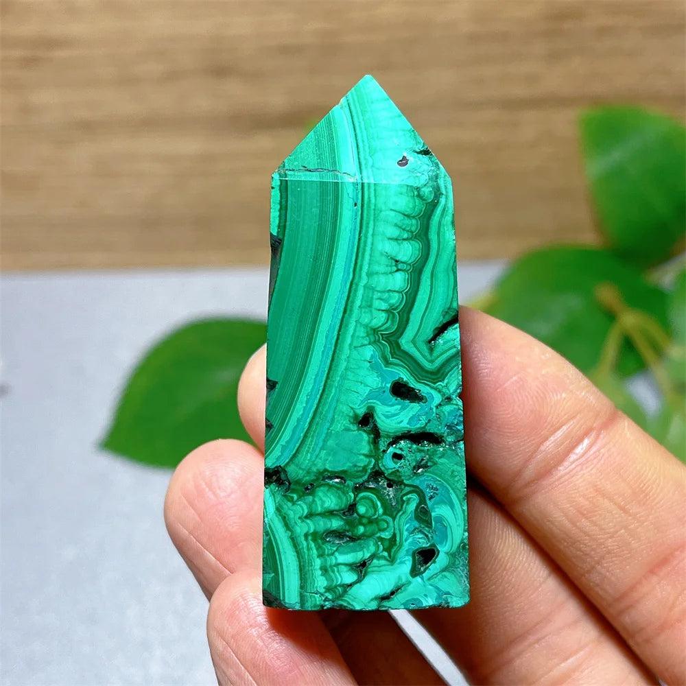 Polished Malachite crystal tower featuring vibrant green banded patterns for transformation and heart chakra healing.