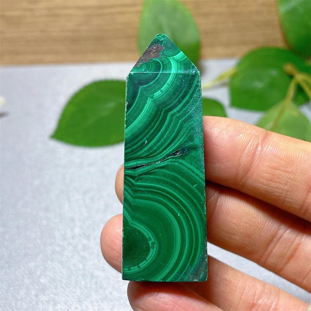 Polished Malachite crystal tower with vibrant green banded patterns, perfect for heart chakra healing and transformation.