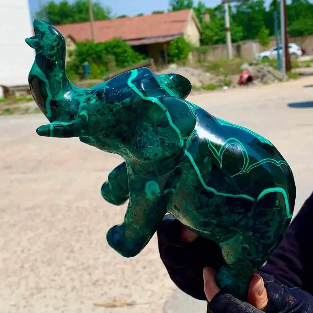 Vivid Malachite Elephant Carving: deep green, banded crystal sculpture with trunk raised for good fortune and transformation.