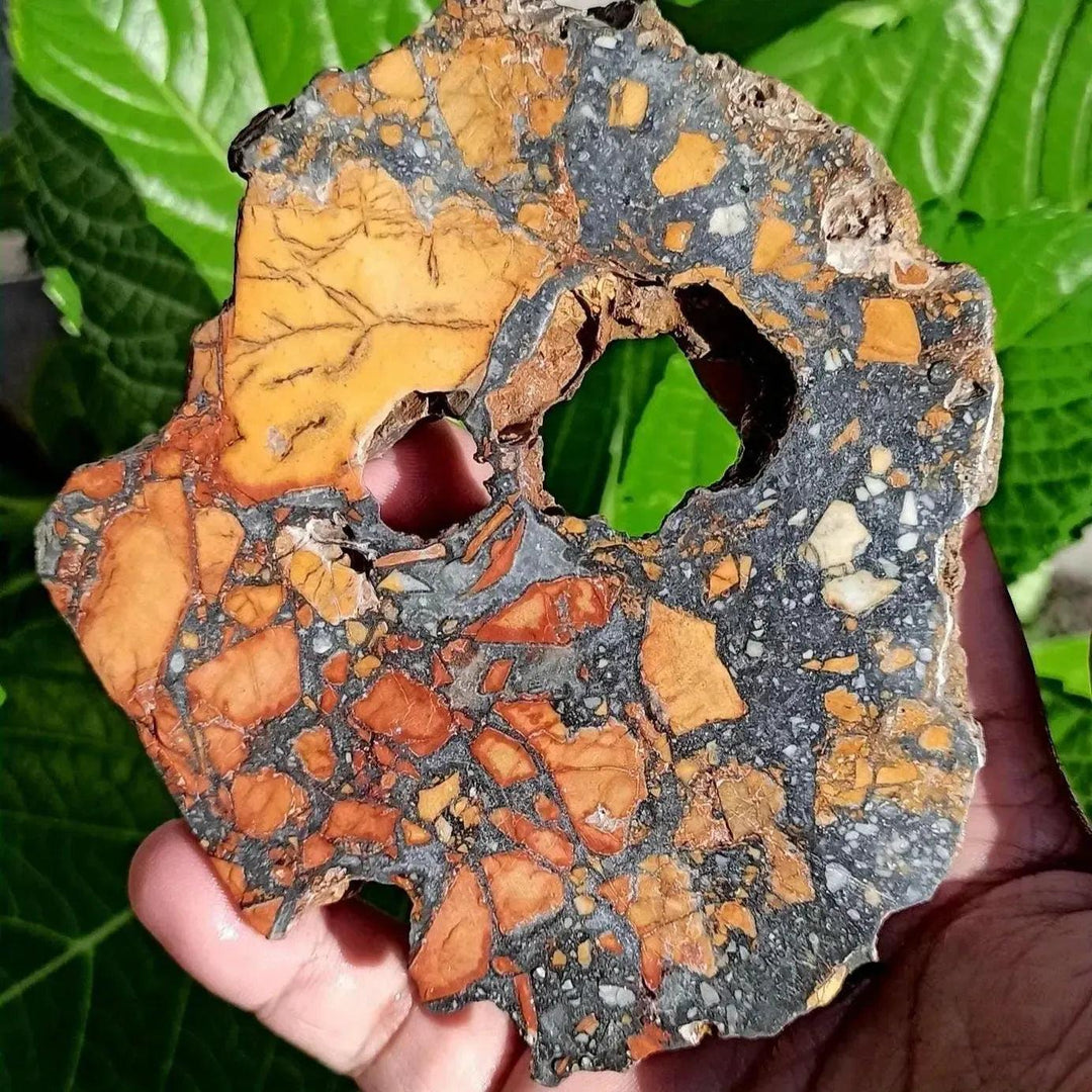 Maligano Jasper crystal slab from Crystal Destiny, featuring bold yellow, black, and white swirling patterns with a natural hole.