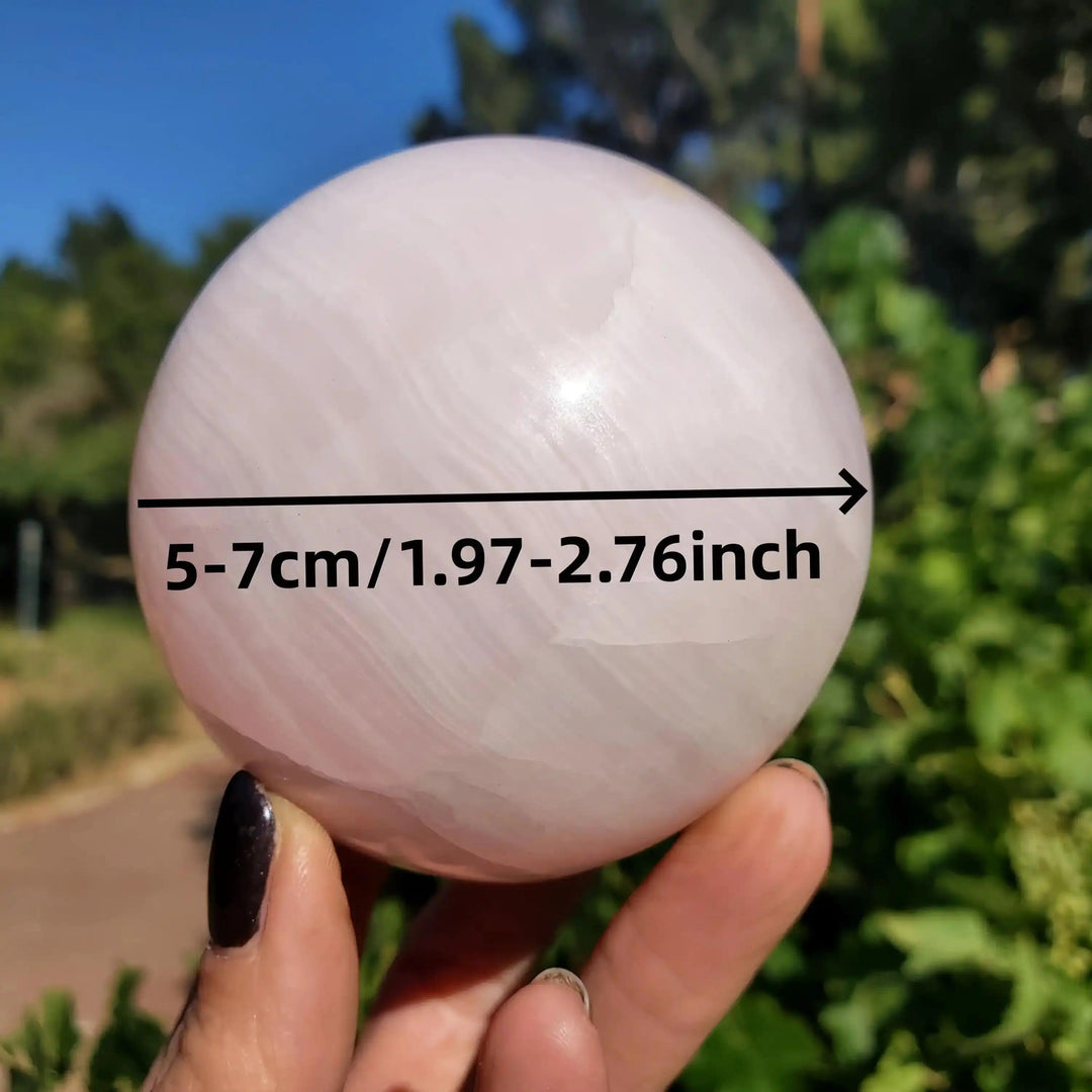 Hand-polished Mangano Calcite sphere in soft pastel pink with white banding, 5-7cm, perfect for Heart chakra healing.