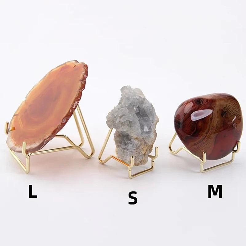 Gold metal arm crystal display easels in small, medium, and large sizes holding agate, celestite, and polished jasper.