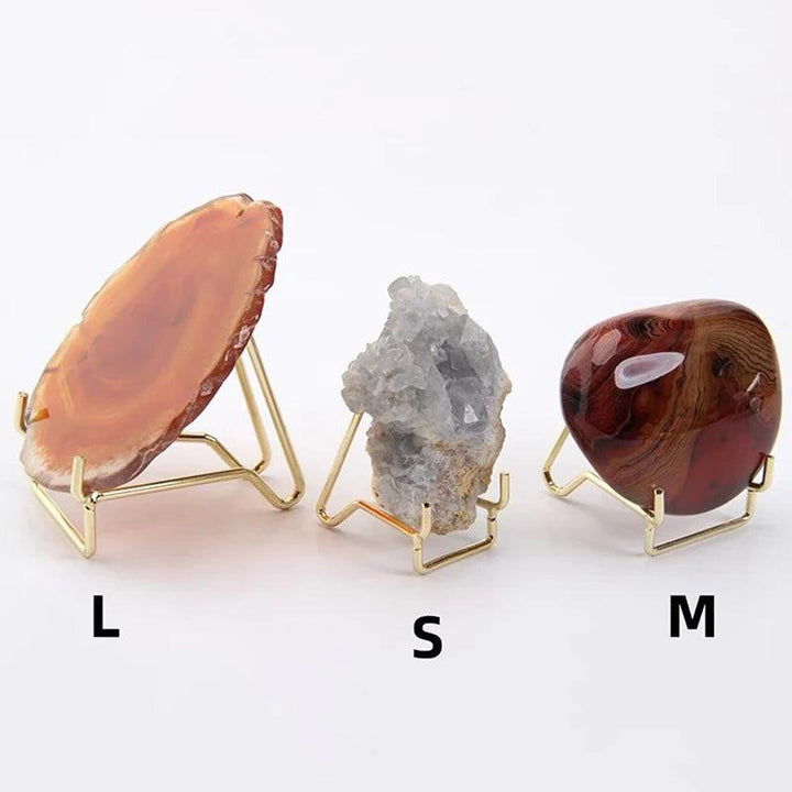 Gold metal arm crystal display easels in small, medium, and large sizes holding agate, celestite, and polished jasper.