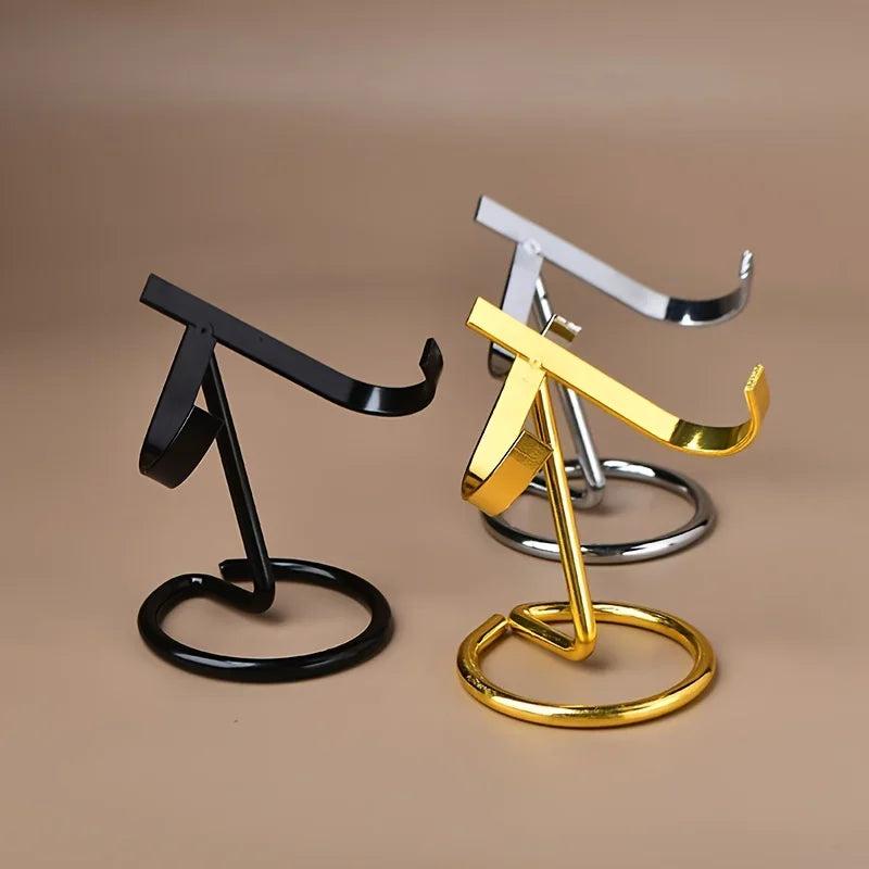 Three sleek metal crystal display stands in black, gold, and silver finishes, designed to hold various crystal specimens.