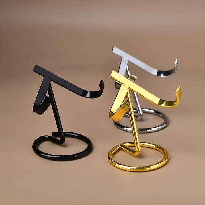 Three sleek metal crystal display stands in black, gold, and silver finishes, designed to hold various crystal specimens.