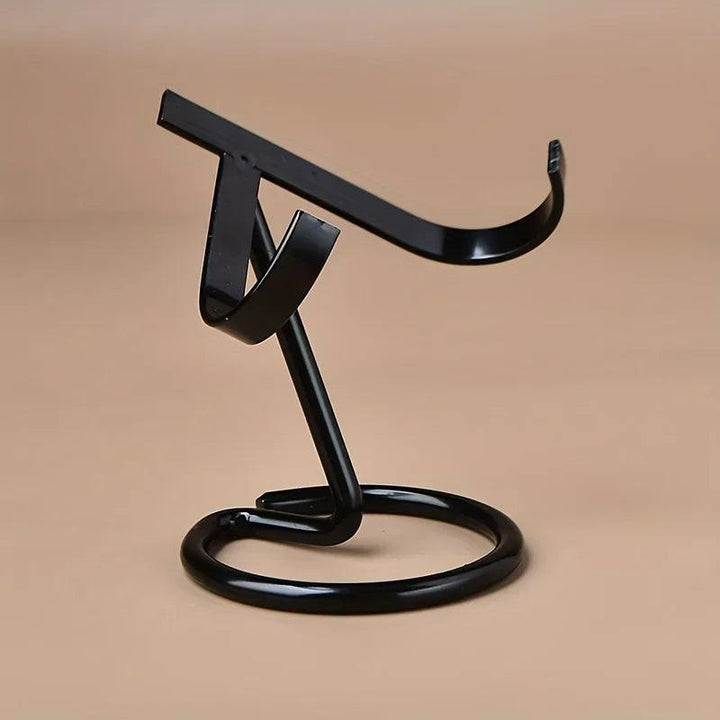 Black metal crystal display stand with a sleek, modern design and sturdy round base.