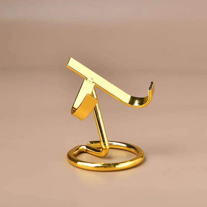 Small gold metal display stand for crystals, featuring a sleek, modern design with a weighted base.