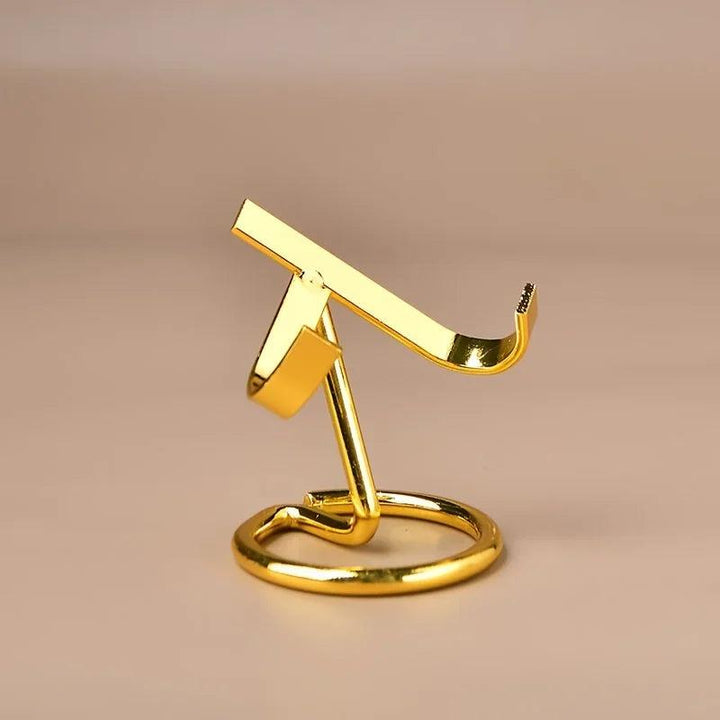 Small gold metal display stand for crystals, featuring a sleek, modern design with a weighted base.