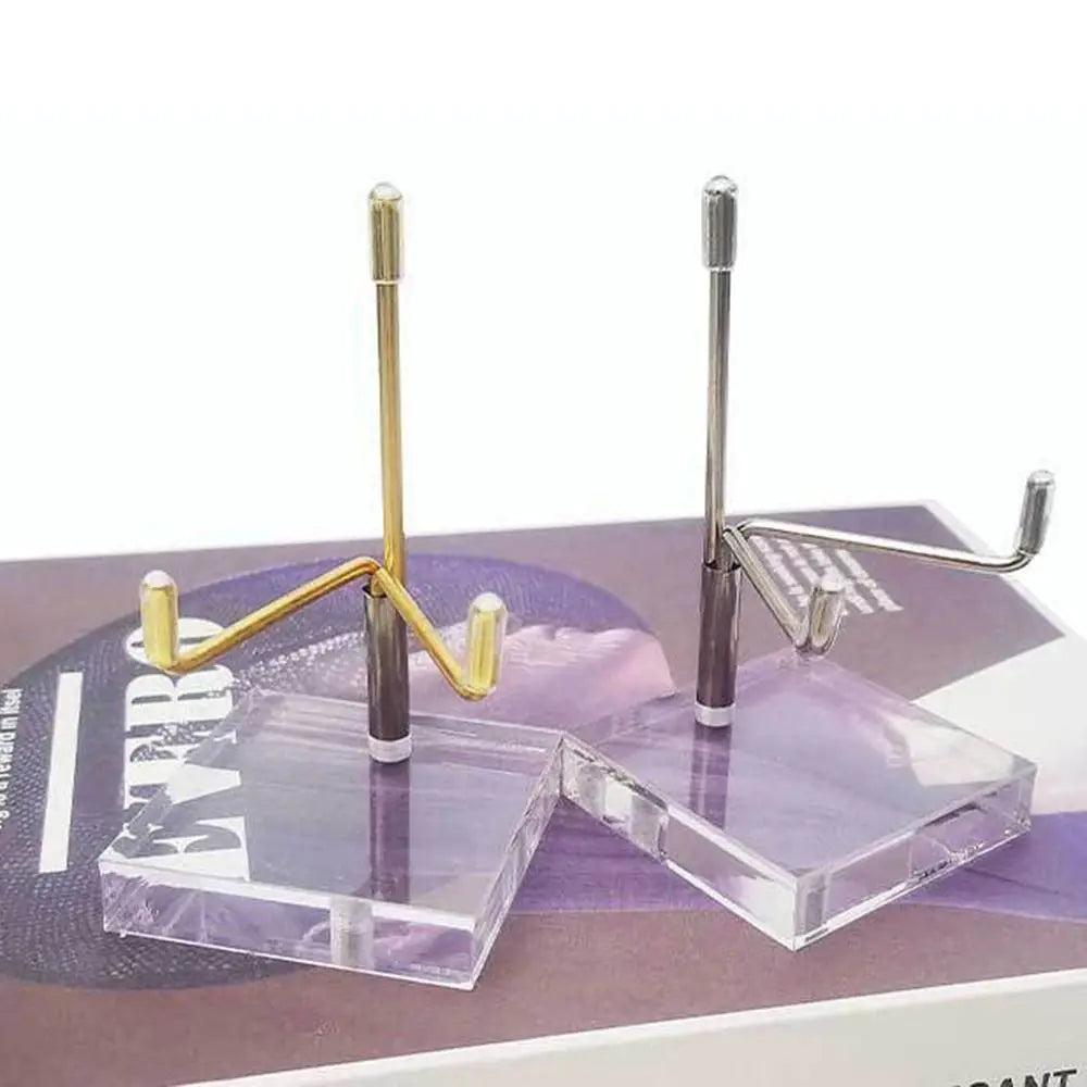 Gold and silver metal crystal ball display stands with clear acrylic bases, designed for spheres.