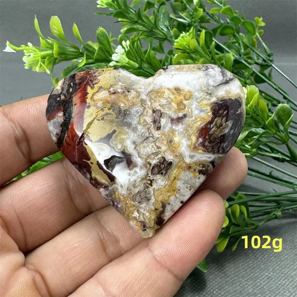Mexican Agate Crystal Freeform, a 102g heart-shaped stone with warm oranges, deep reds, and creamy whites.