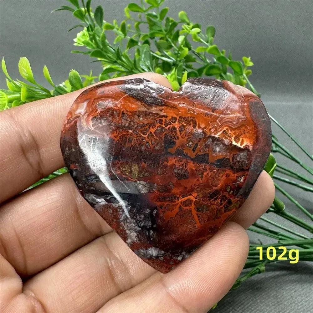 Mexican Agate heart crystal, 102g, with warm oranges, deep reds, and earthy browns for strength and grounding.