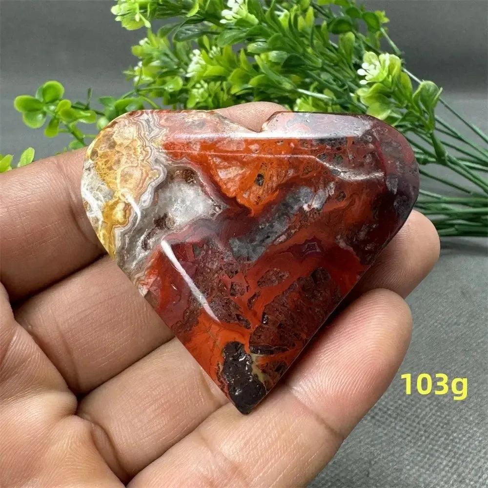 Mesmerizing Mexican Agate heart, 103g, with warm oranges, deep reds, and creamy whites for strength and grounding.