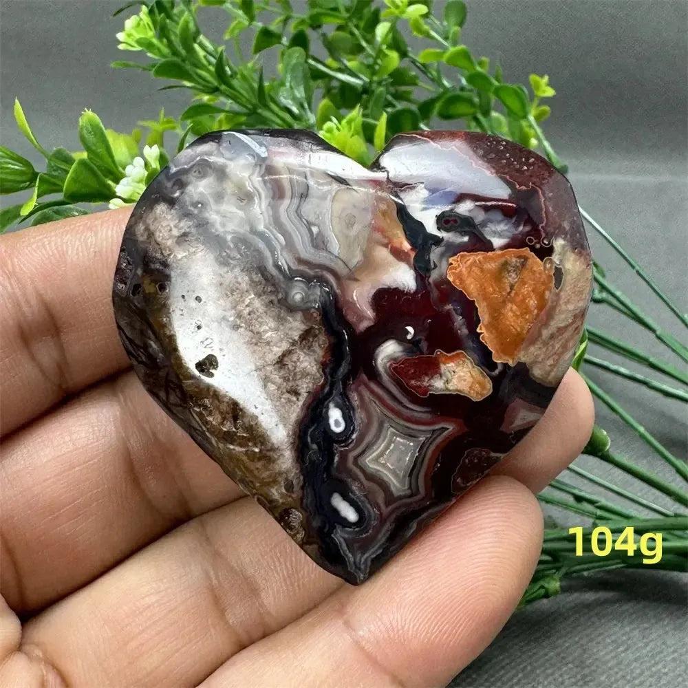 Mesmerizing Mexican Agate heart, 104g, with warm oranges, deep reds, creamy whites, and earthy browns.