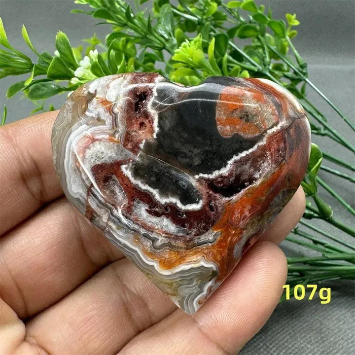 Mesmerizing Mexican Agate heart, 107g, with warm oranges, deep reds, creamy whites, and earthy browns. Strength & grounding.